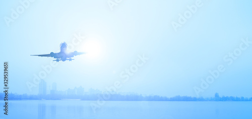 View of the lake and the plane in the sky in the fog. Cold