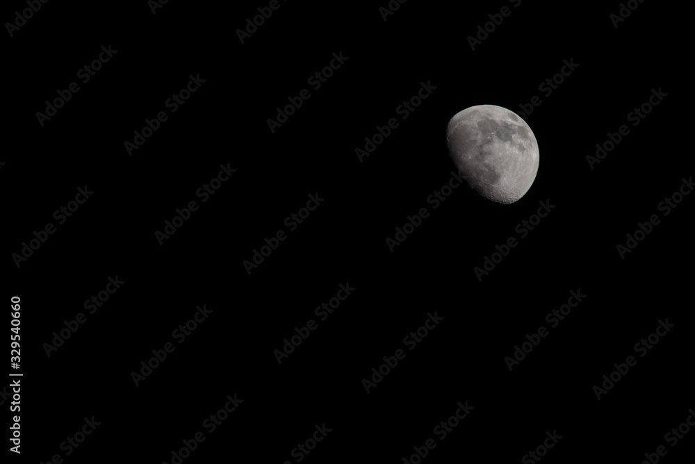 Closeup of a Three Quarter Moon in a Black Sky Closeup of a Three Quarter Moon in a Black Sky