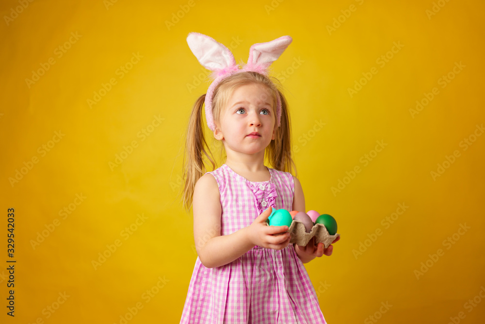 Easter concept. Toddler blonde happy girl with bunny ears Easter concept. Toddler blonde happy girl with bunny ears
