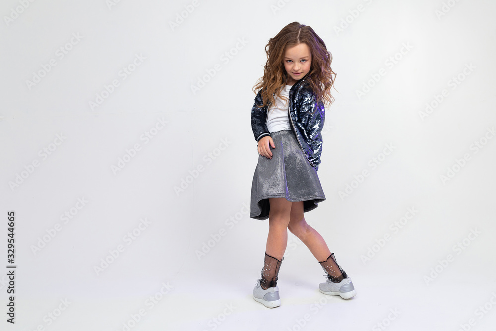 european teenager girl in a beautiful manner dancing in full growth on a light studio background with copy space european teenager girl in a beautiful manner dancing in full growth on a light studio background with copy space