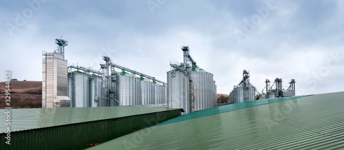 Silos for storage of grain, silo roof close-up, view through the roofs of warehouses