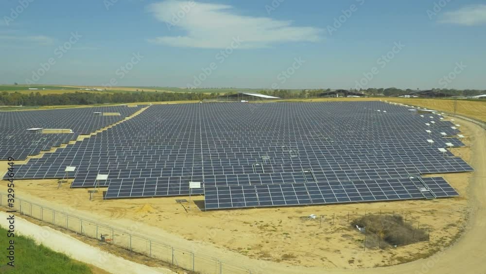 aerial shot orbits above the industrial solar panel energy farm at sunlight aerial shot orbits above the industrial solar panel energy farm at sunlight