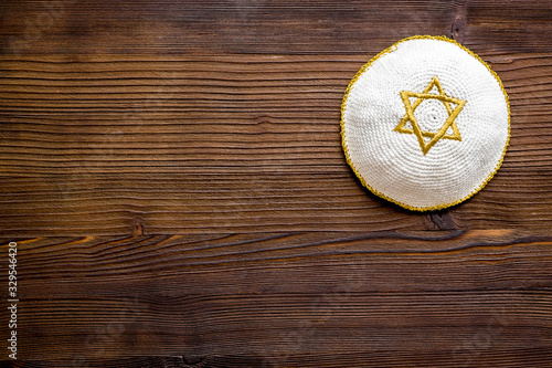 Jewish Kippah Yarmulkes hats with Star of David on wooden table. Religion Judaisim symbol. Top view, space for text