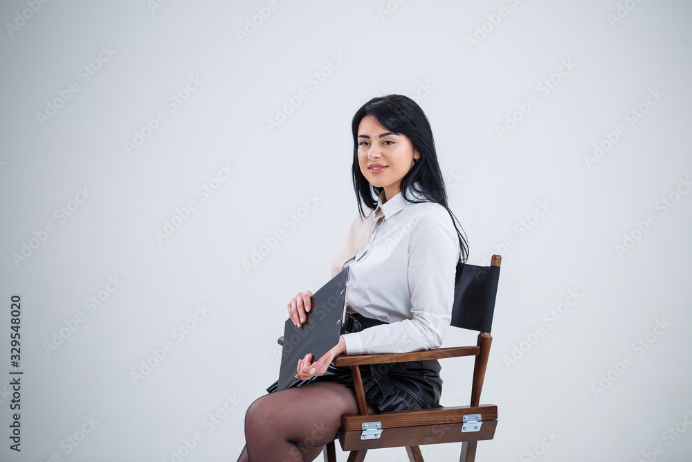 woman teacher, business coach, mentor holds a folder with a new business project in her hands woman teacher, business coach, mentor holds a folder with a new business project in her hands