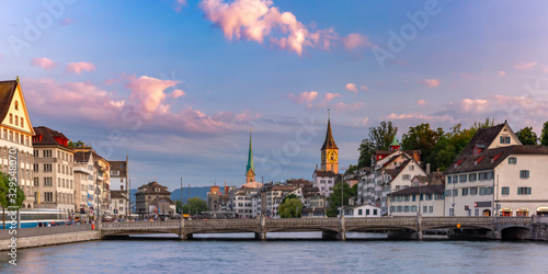 Panoramic view of famous Fraumunster and Church of St Peter and river Limmat at sunrise in Old Town of Zurich  the largest city in Switzerland