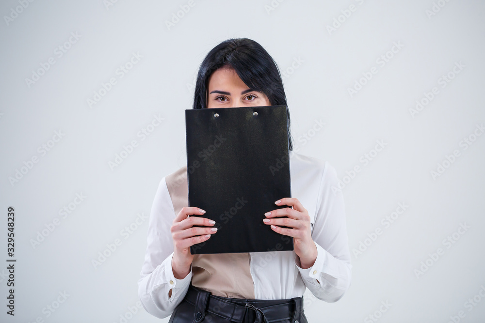 woman teacher, business coach, mentor holds a folder with a new business project in her hands woman teacher, business coach, mentor holds a folder with a new business project in her hands