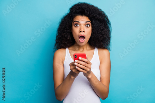 Close-up portrait of her she nice attractive lovely addicted overwhelmed amazed wavy-haired girl using digital gadget browsing news isolated on bright vivid shine vibrant blue color background