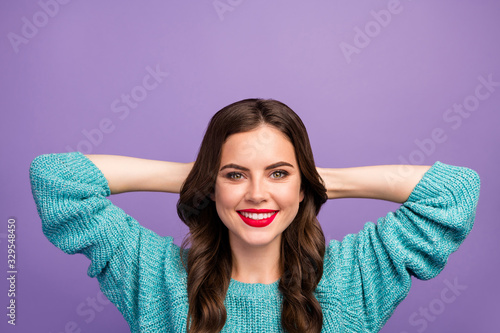 Closeup photo of pretty lady holding hands behind head toothy beaming smiling resting spending free time leisure wear blue sweater isolated purple color background #329548450