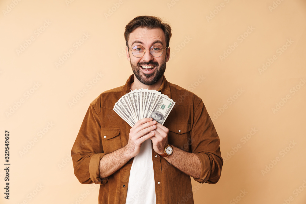 Unshaved man isolated holding money. Unshaved man isolated holding money.