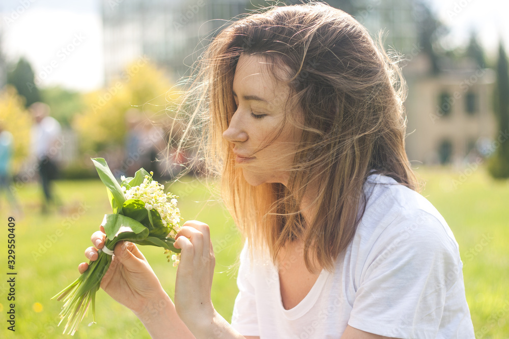 Woman holding a bouquet of lilly of valley flowers Woman holding a bouquet of lilly of valley flowers