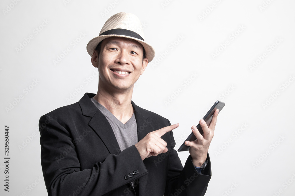 Adult Asian man with a computer tablet. Adult Asian man with a computer tablet.