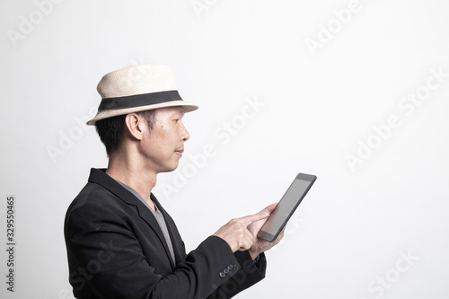 Adult Asian man  with a computer tablet.