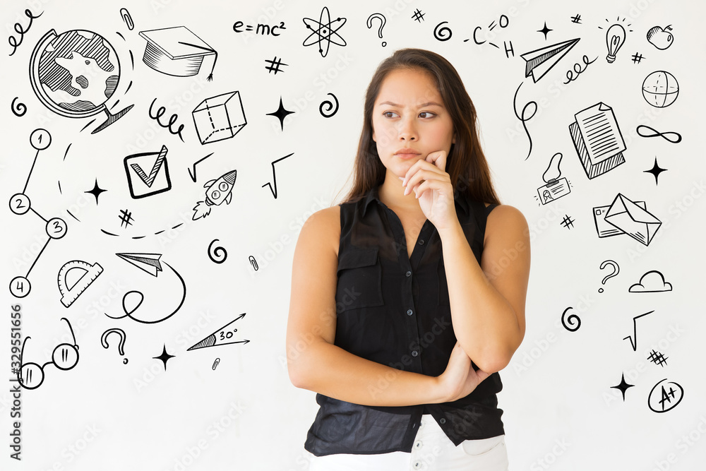 Pensive young woman with hand on chin and hand drawn studying sketches. Portrait of serious young Asian woman looking aside isolated on white background. Thinking concept Pensive young woman with hand on chin and hand drawn studying sketches. Portrait of serious young Asian woman looking aside isolated on white background. Thinking concept