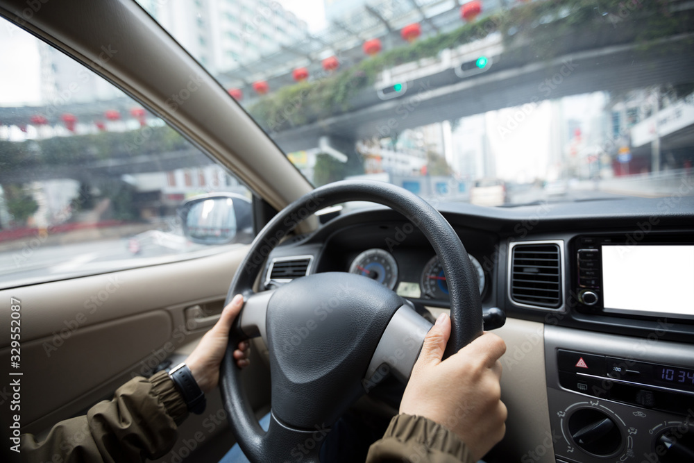 Driving car on city street waiting infront of the traffic lights during Chinese spring festival in China