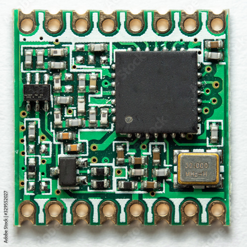 Macro photo of a small electronic LoRa Module isolated on white background. PCB assembly