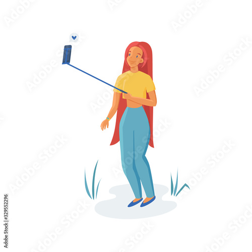 Young woman makes selfie isolated on white background. Ginger teenage girl with monopod.