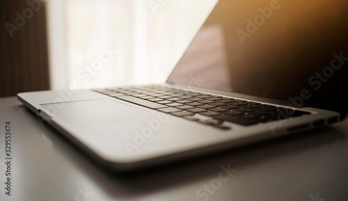 laptop device isolated on table with sunshine tone