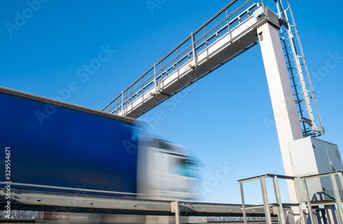truck drive through the highway through the toll gate, toll charges, blurred motion in the image