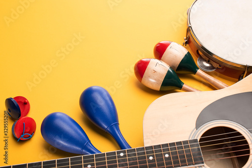 Εκτύπωση καμβά Wooden colorful and blue maracas with tambourine, castanets and acoustic guitar