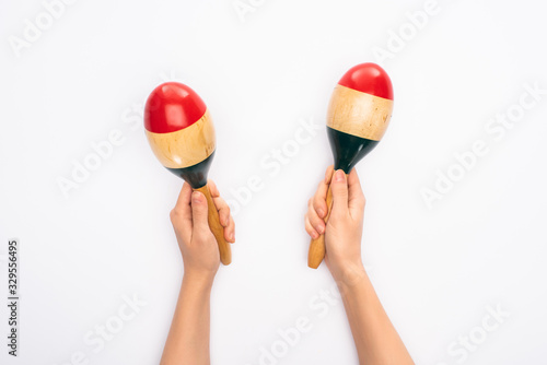 Cropped view of woman holding maracas on white background photo