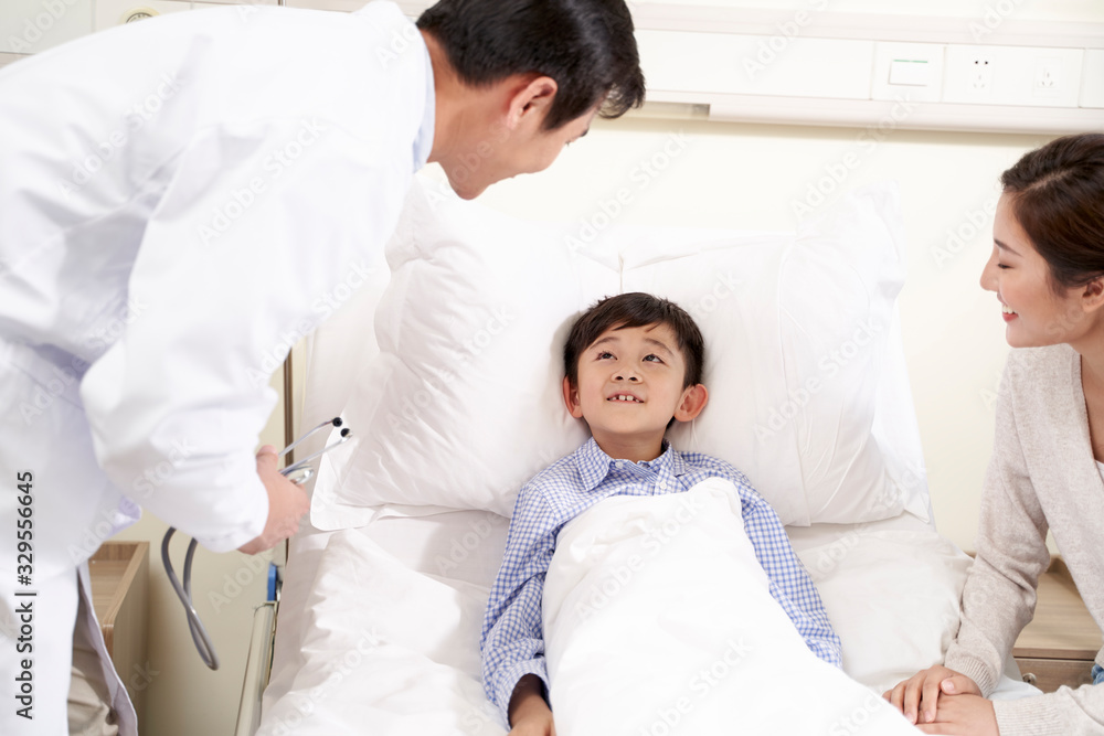 young asian doctor talking to child patient and mother young asian doctor talking to child patient and mother