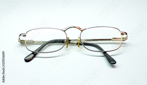 Vision glasses are isolated on a white background. Real Granny glasses for reading books and Newspapers . Glasses with close -up lenses. Old- fashioned classic glasses for vision correction.