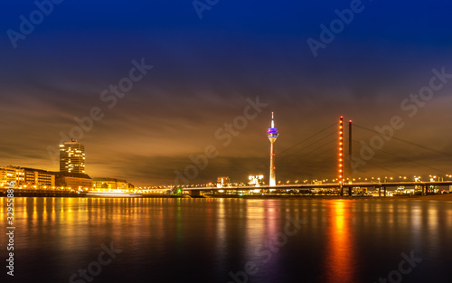 Night view of Dusseldorf on the bank of Rhine in Germany  Rheinturm and skyscrapers