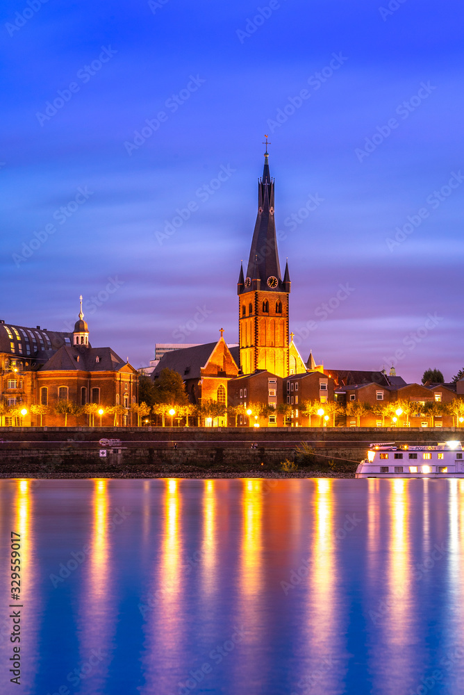 Saint Lambertus Catholic Church; night view of Dusseldorf City on the bank of Rhine in Germany