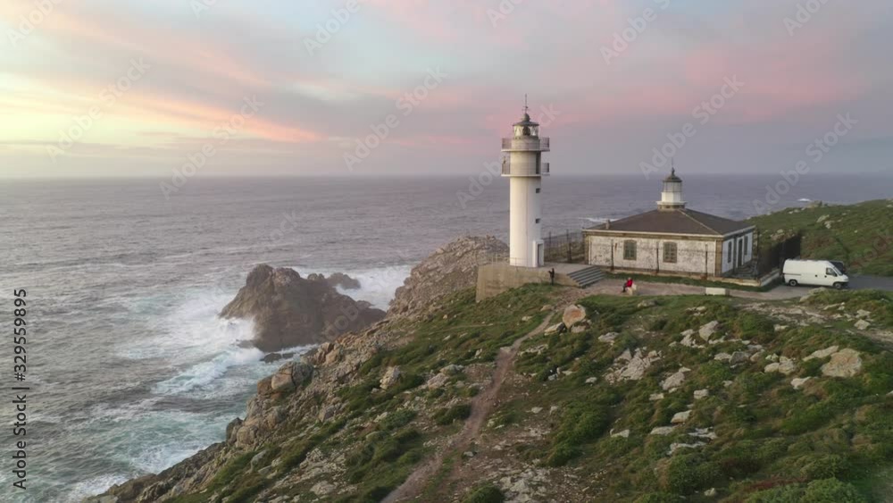 Amazing drone aerial sea landscape view of Cape Tourinan Lighthouse at sunset with pink clouds, in Spain Amazing drone aerial sea landscape view of Cape Tourinan Lighthouse at sunset with pink clouds, in Spain