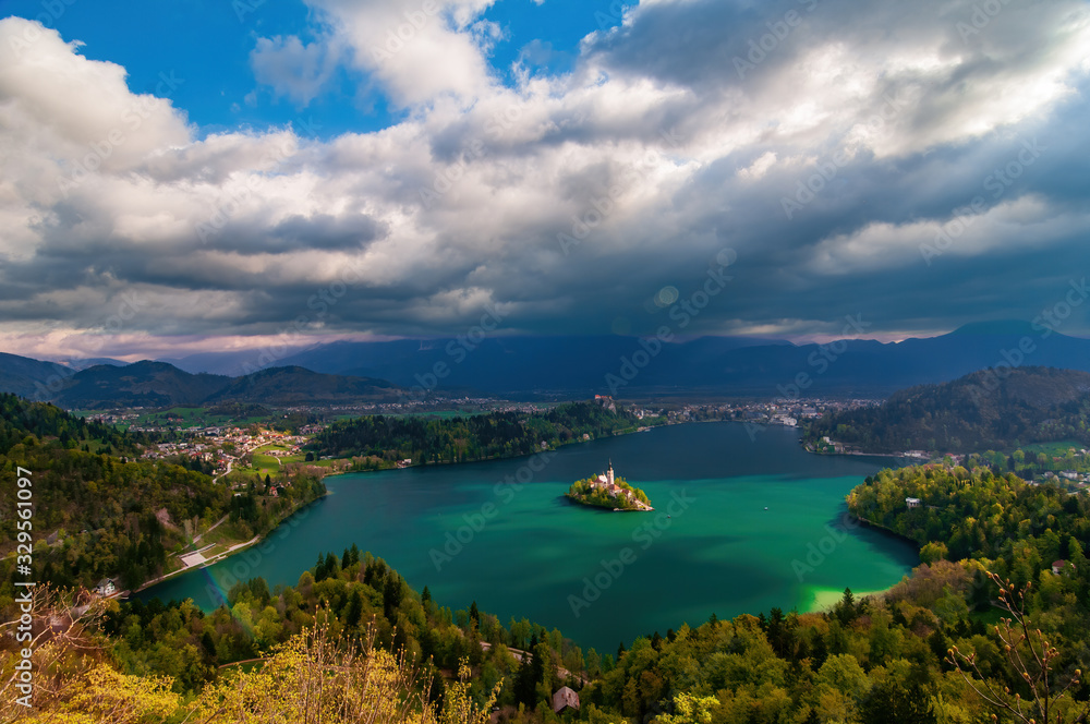 Magnificent panoramic top view of Lake Bled under dramatic clouds