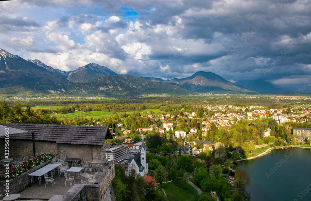 Panoramic view from the castle on sunlit valley with Bled town, Slovenia