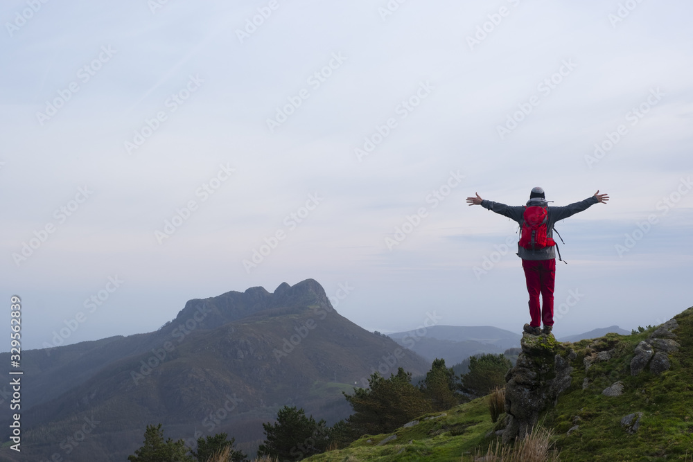 Hiker dressed in red in the natural park of Aiako Harriak, Euskadi