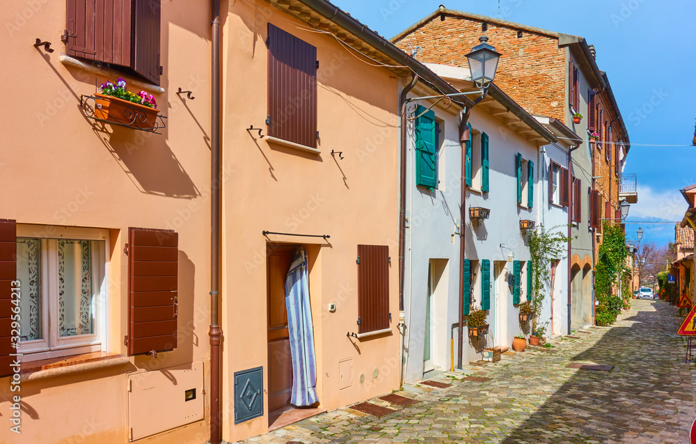 Perspective of an old street with colorful houses italian town