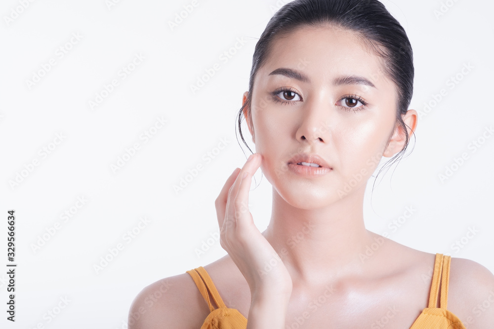 Fashion of a beautiful young asian woman in a pretty yellow dress. Girl posing smiling isolated on white background.Natural skin makeup. fashion beauty and style. Fashion of a beautiful young asian woman in a pretty yellow dress. Girl posing smiling isolated on white background.Natural skin makeup. fashion beauty and style.