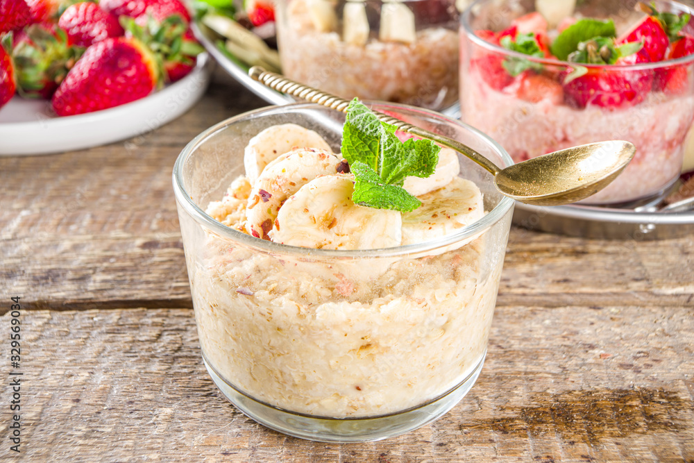 Set various fruit overnight oatmeal. Oats porridge with strawberry, bananas, chocolate, nuts in small portion jars. Summer breakfast oatmeal. Healthy vegan diet snack. Set various fruit overnight oatmeal. Oats porridge with strawberry, bananas, chocolate, nuts in small portion jars. Summer breakfast oatmeal. Healthy vegan diet snack.