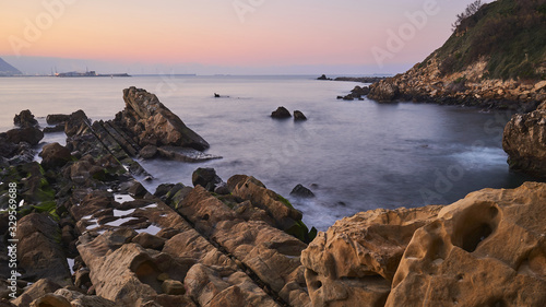 Sunset in a beach Rocks and sea, during the golden hour Long exposure Getxo Basque Coun try Kantarepe Beach