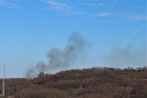 Gray smoke spreads over the field.