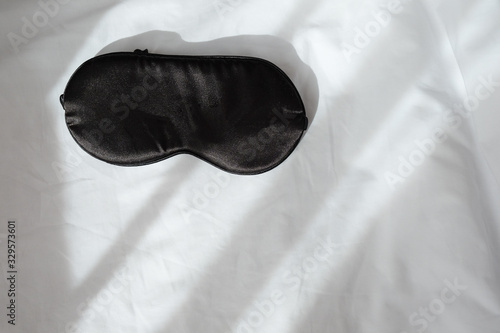 Wallpaper Mural Silk black sleep mask without inscription on white rumpled sheets. Top view, flat lay. Horizontal. Copy spase. Concept of rest, awakening, sleep. For social media, blog. Minimal style Torontodigital.ca