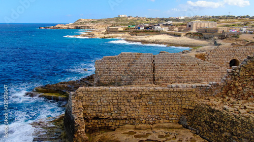 Flight over ancient ruins at the coast of Malta - aerial photography