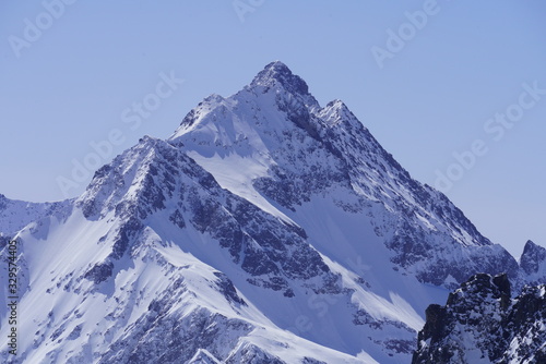 Beautiful snow-capped mountain peak under the sunny sky