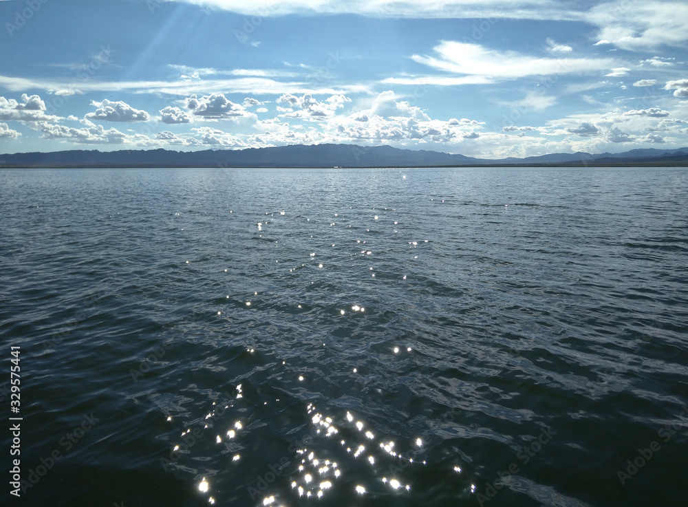 The sunlight shining on the lake; beautiful clouds and landscape