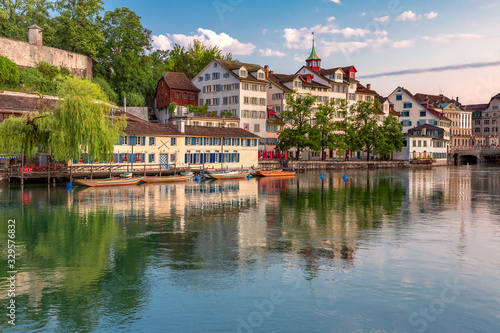 Cozy houses on Limmat river embankment at sunrise in Old Town of Zurich, the largest city in Switzerland © Kavalenkava