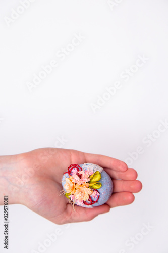 Easter egg in hands on a white isolated background.