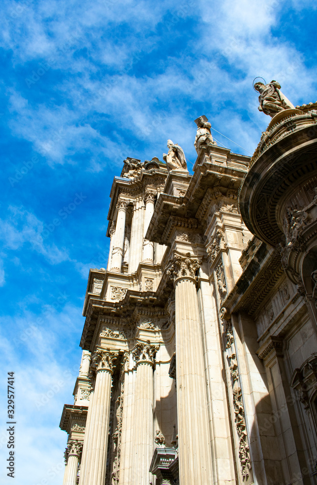 Obraz premium The beautiful cathedral at the city of Murcia, Spain. A side view of the facade of this monument. The building is elaborately decorated in the plateresque style, although the original structure is go