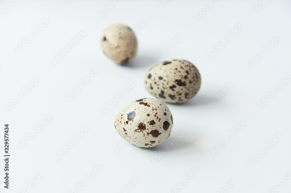 Fototapeta premium Quail eggs on a white background. Bird spotted eggs. Several objects. Healthy food.