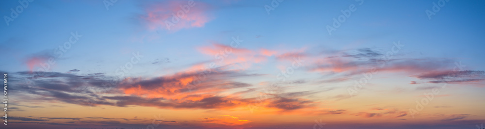 panorama of a blue-pink sunset with clouds of pink hues. sunset on the horizon. photo for the banner. space for text.