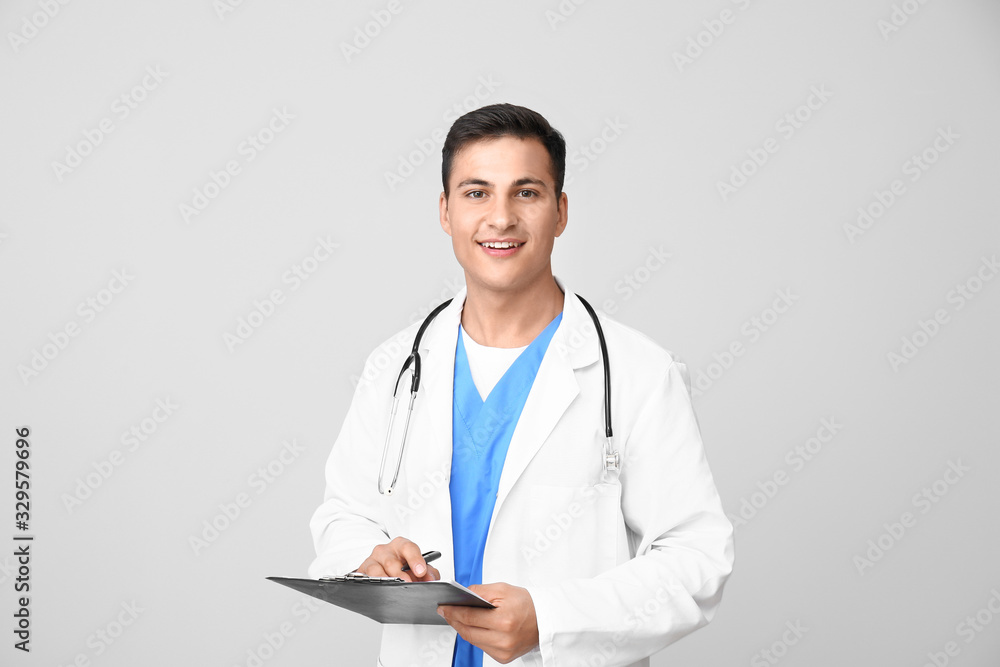 Handsome male doctor on light background Handsome male doctor on light background