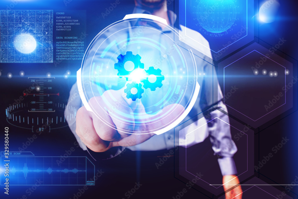 Business, Technology, Internet and network concept. Young businessman working on a virtual screen of the future and sees the inscription: Business, Technology, Internet and network concept. Young businessman working on a virtual screen of the future and sees the inscription: