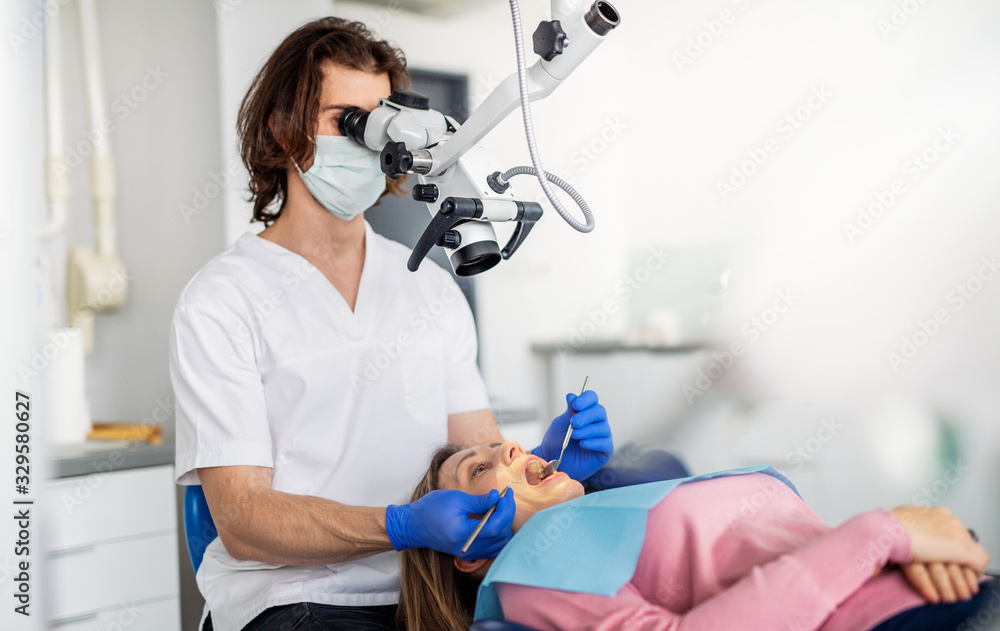 A woman has a dental check-up in dentist surgery.