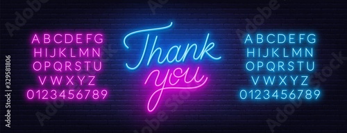 Thank you neon lettering on brick wall background. Neon alphabet on brick wall background.